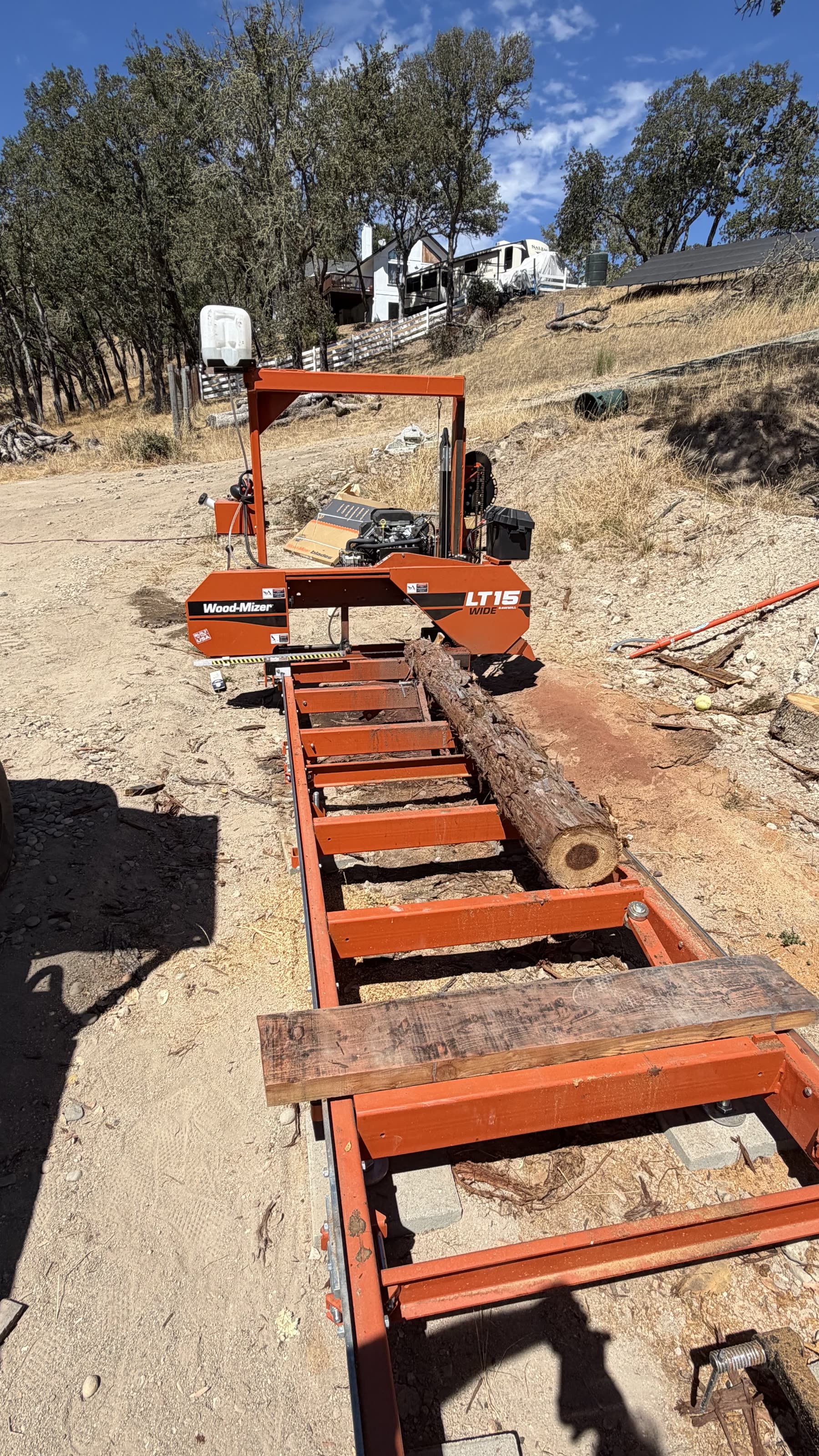Portable sawmill cutting locally sourced redwood