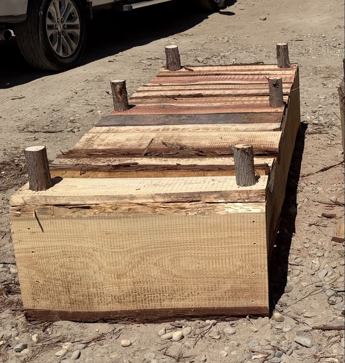 Close view of rough-sawn redwood planter box with natural post corners